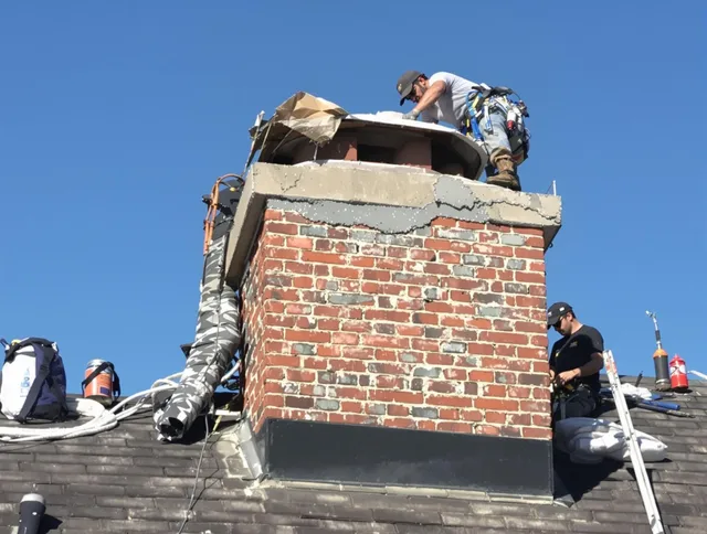 Brecksville Chimney Sweep installing a custom chimney crown in Brecksville, OH