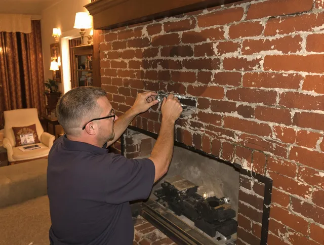 Brecksville Chimney Sweep expert fixing a fireplace in Brecksville, OH